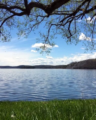Panoramic view of a sunrise on Lake Bomoseen, VT, under a clear sky.