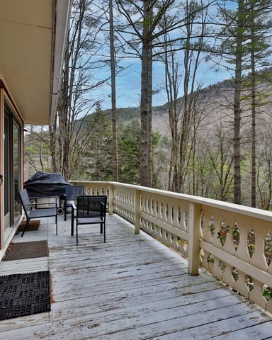 Interior of a luxurious rental home in Woodstock, Vermont. Large windows with a view of the Green Mountains.